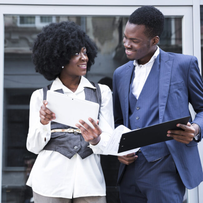 young-african-businessman-businesswoman-holding-digital-tablet-clipboard-looking-each-other young-african-businessman-businesswoman-holding-digital-tablet-clipboard-looking-each-other